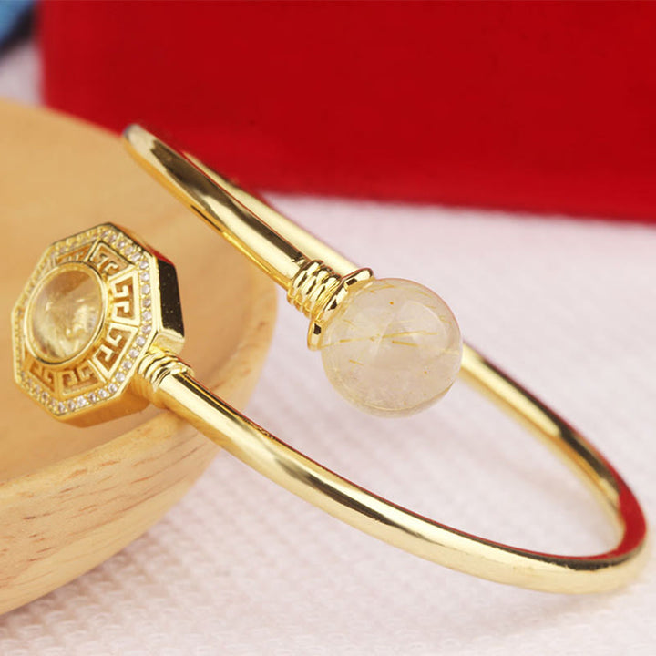 Pulsera brazalete de coraje de Feng Sheng Shui Qi con molino de viento giratorio de cobre y latón con Buddha Stones y cuarzo rutilado