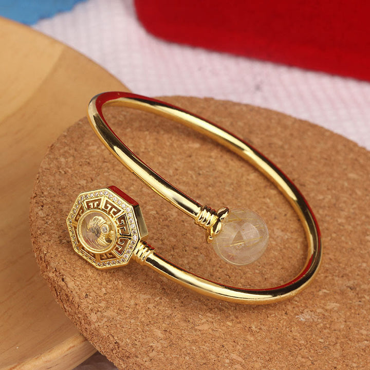 Pulsera brazalete de coraje de Feng Sheng Shui Qi con molino de viento giratorio de cobre y latón con Buddha Stones y cuarzo rutilado