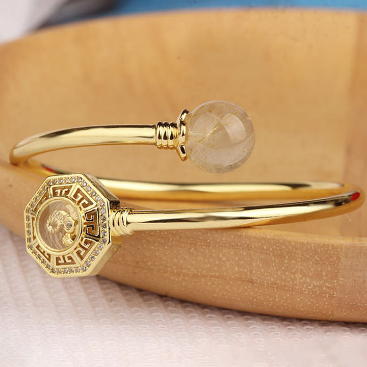 Pulsera brazalete de coraje de Feng Sheng Shui Qi con molino de viento giratorio de cobre y latón con Buddha Stones y cuarzo rutilado