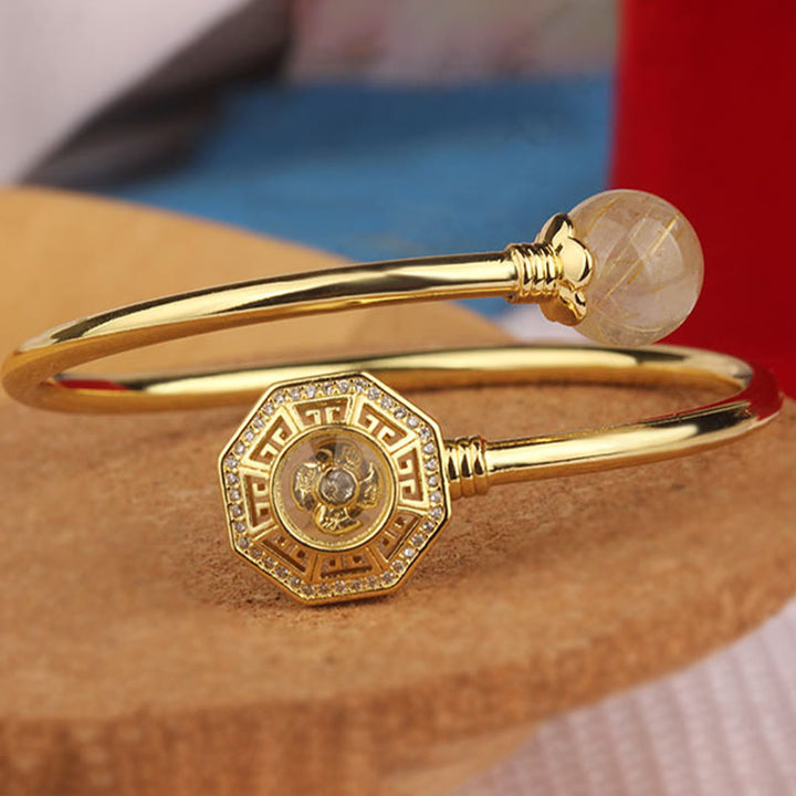 Pulsera brazalete de coraje de Feng Sheng Shui Qi con molino de viento giratorio de cobre y latón con Buddha Stones y cuarzo rutilado