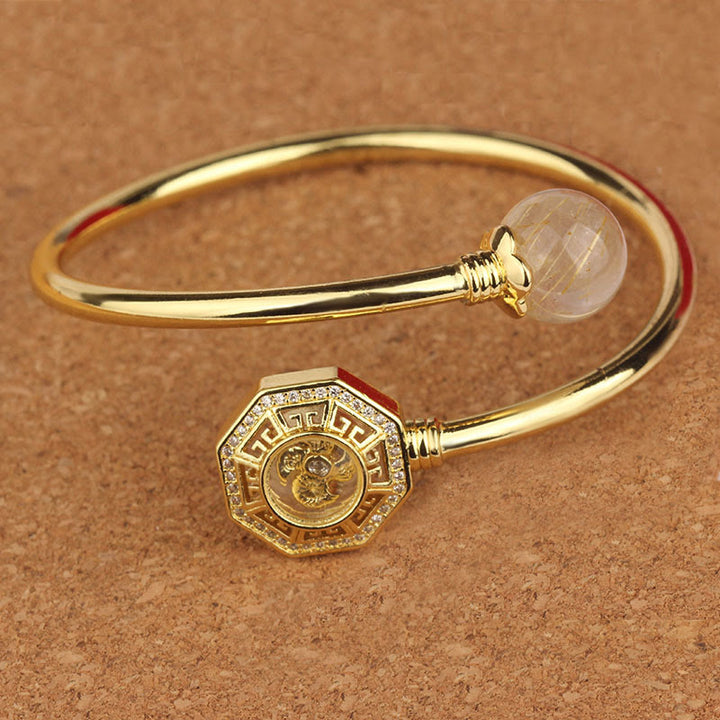 Pulsera brazalete de coraje de Feng Sheng Shui Qi con molino de viento giratorio de cobre y latón con Buddha Stones y cuarzo rutilado