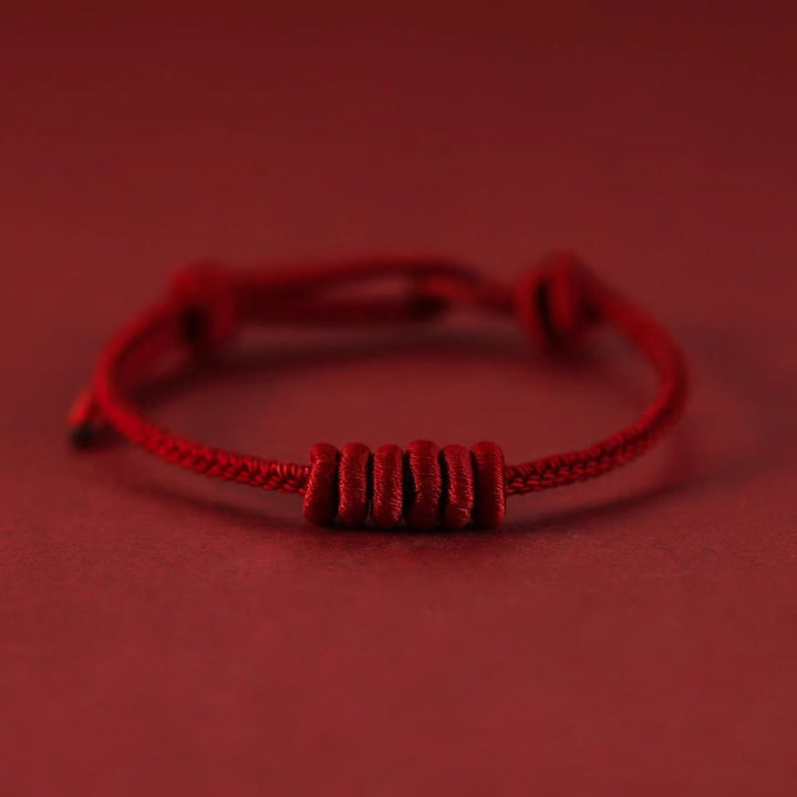 Pulsera de fuerza de ocho hilos con hilo rojo y Buddha Stones