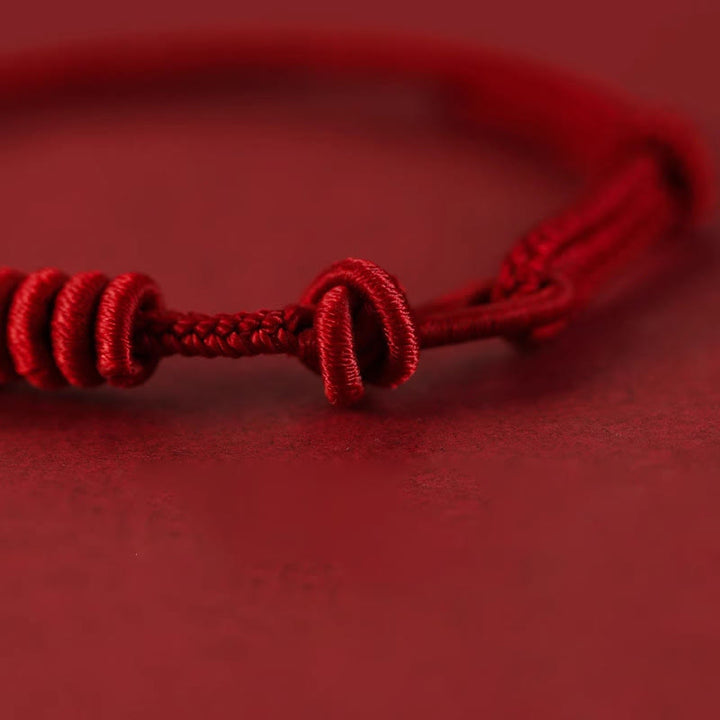 Pulsera de fuerza de ocho hilos con hilo rojo y Buddha Stones
