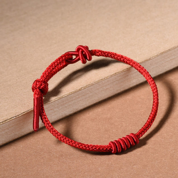 Pulsera de fuerza de ocho hilos con hilo rojo y Buddha Stones