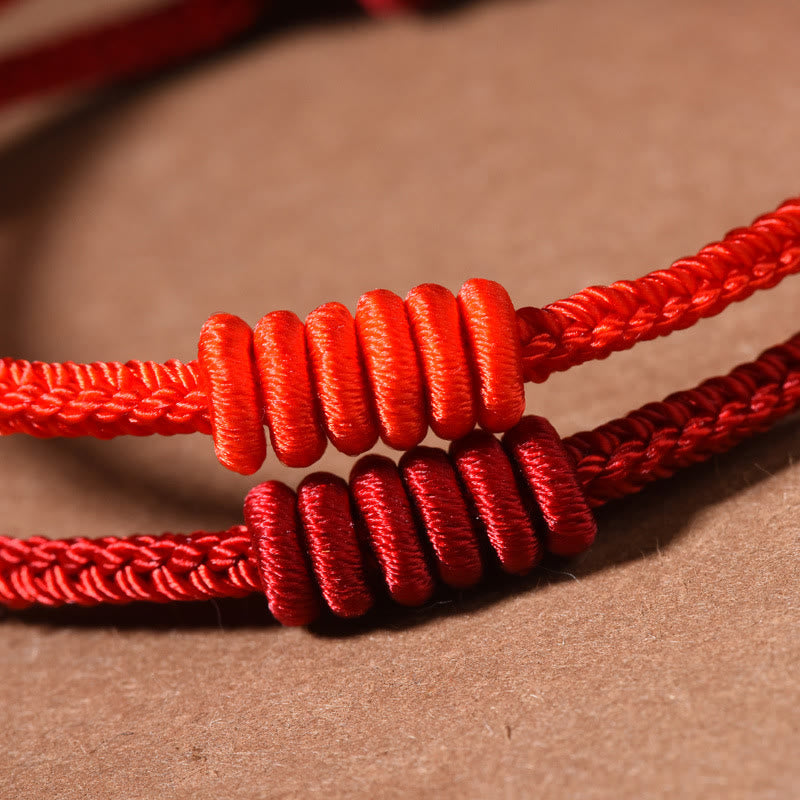 Pulsera de fuerza de ocho hilos con hilo rojo y Buddha Stones