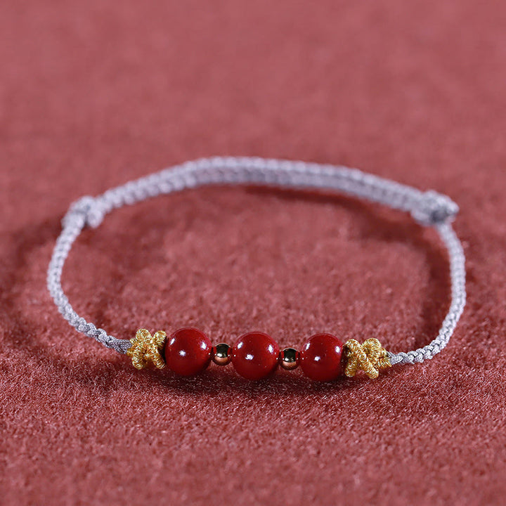 Pulsera de cinabrio con hilo colorido y Buddha Stones