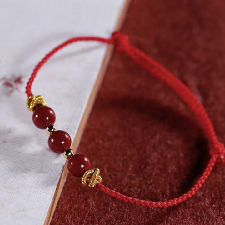 Pulsera de cinabrio con hilo colorido y Buddha Stones