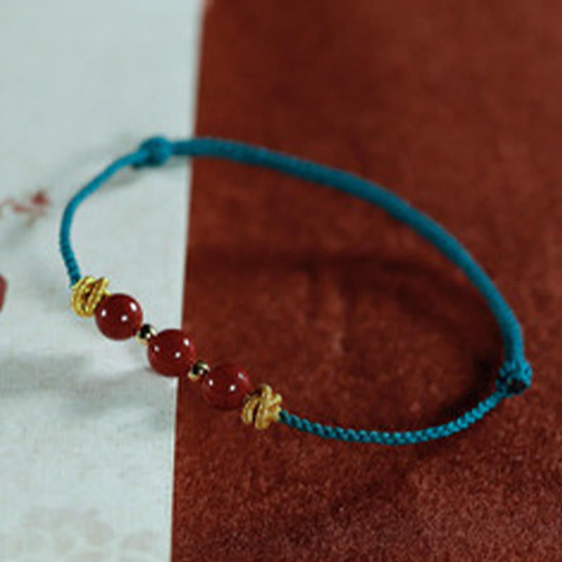 Pulsera de cinabrio con hilo colorido y Buddha Stones