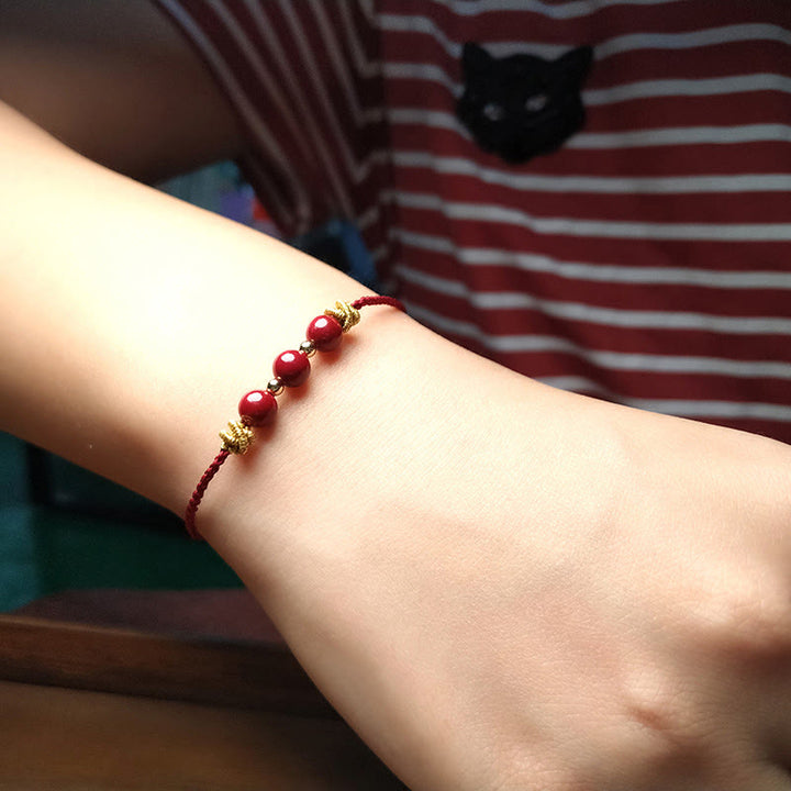 Pulsera de cinabrio con hilo colorido y Buddha Stones