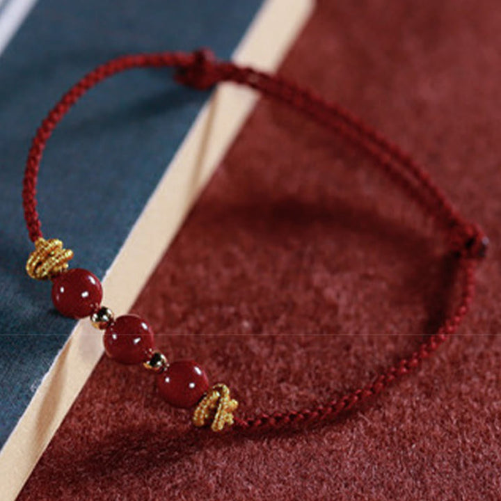 Pulsera de cinabrio con hilo colorido y Buddha Stones