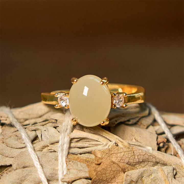 Anillo de prosperidad de cobre con forma de huevo de circonita y jade hetiano natural con Buddha Stones