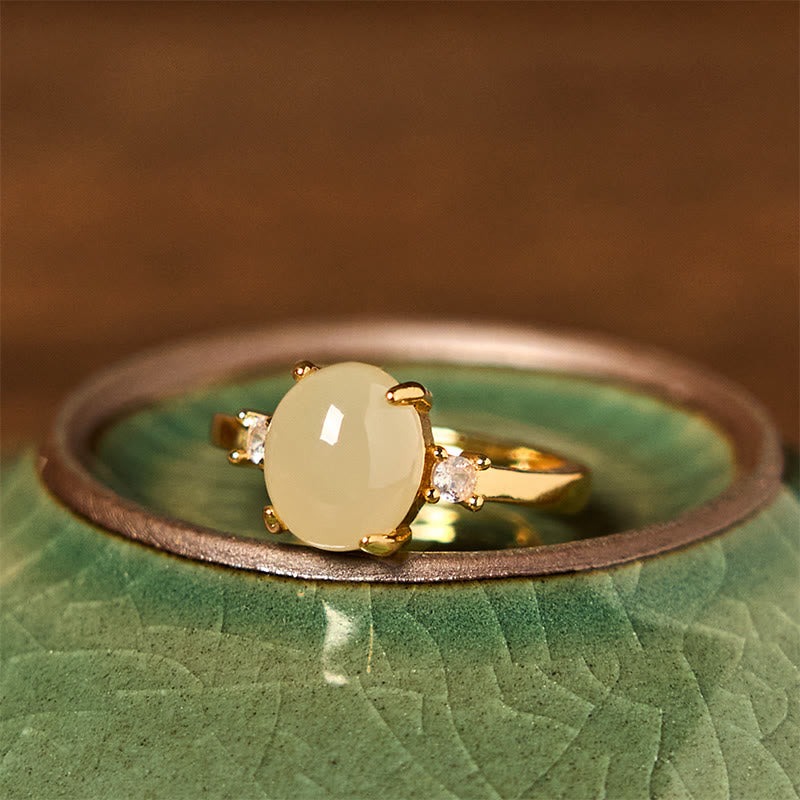 Anillo de prosperidad de cobre con forma de huevo de circonita y jade hetiano natural con Buddha Stones