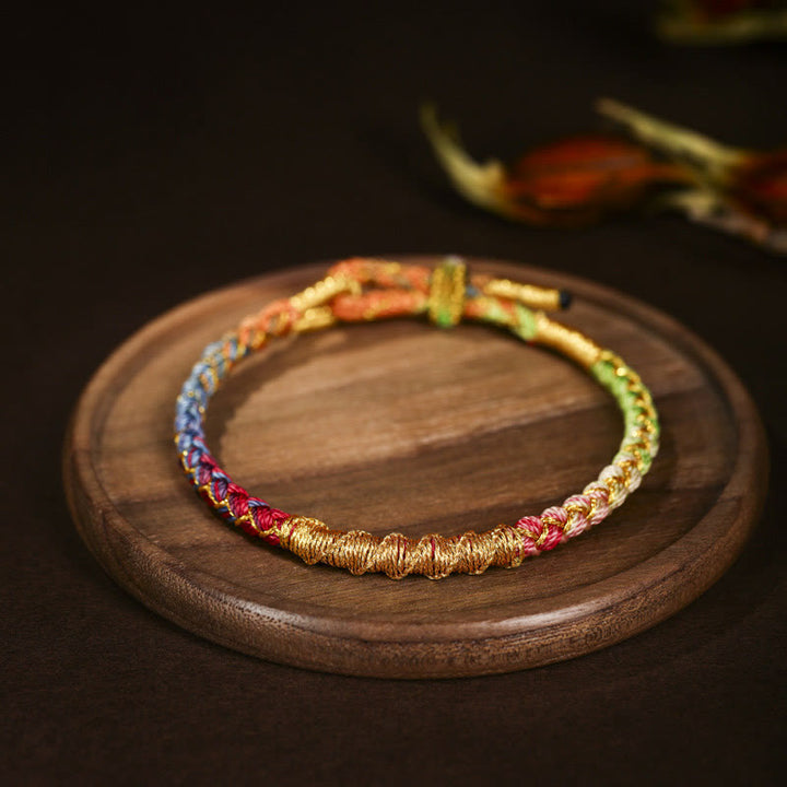 Pulsera trenzada de protección con nudo de escamas de dragón y hilo dorado tibetano de Buddha Stones