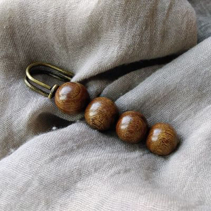 Broche curativo con cuentas de peltogyne, agathis alba, sándalo y madera de ébano de Buddha Stones
