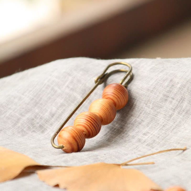 Broche curativo con cuentas de peltogyne, agathis alba, sándalo y madera de ébano de Buddha Stones