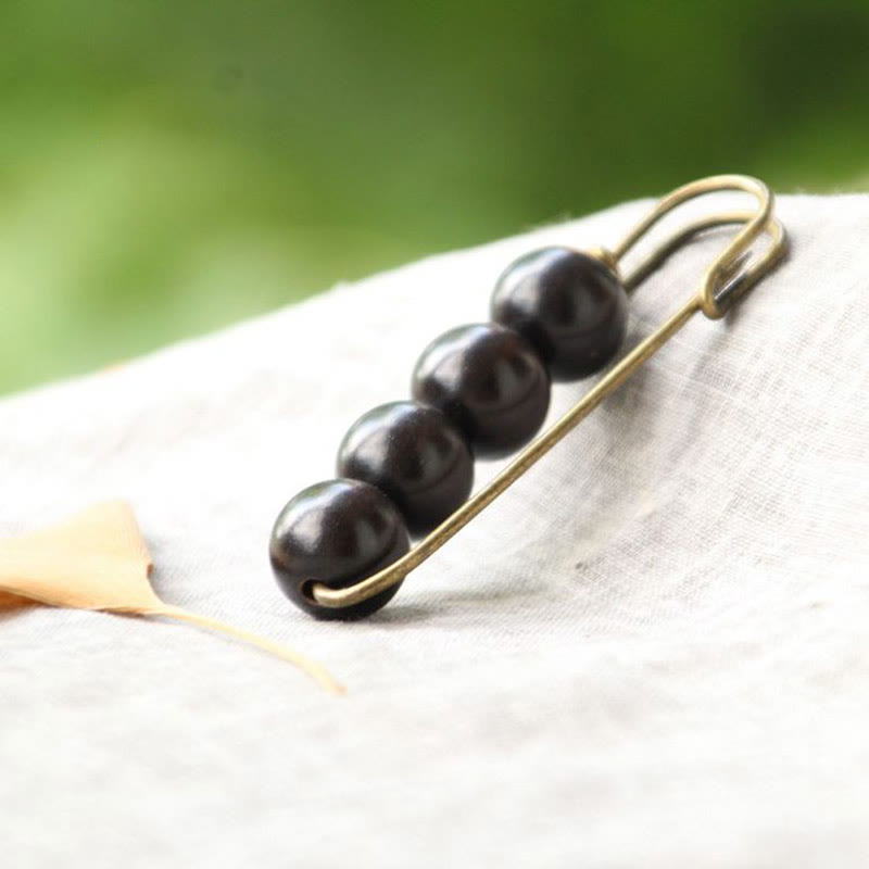 Broche curativo con cuentas de peltogyne, agathis alba, sándalo y madera de ébano de Buddha Stones