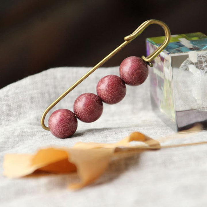 Broche curativo con cuentas de peltogyne, agathis alba, sándalo y madera de ébano de Buddha Stones