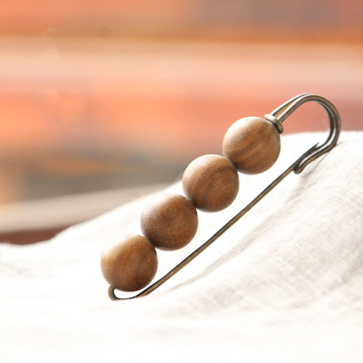 Broche curativo con cuentas de peltogyne, agathis alba, sándalo y madera de ébano de Buddha Stones