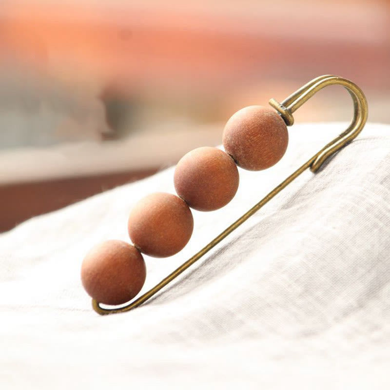 Broche curativo con cuentas de peltogyne, agathis alba, sándalo y madera de ébano de Buddha Stones