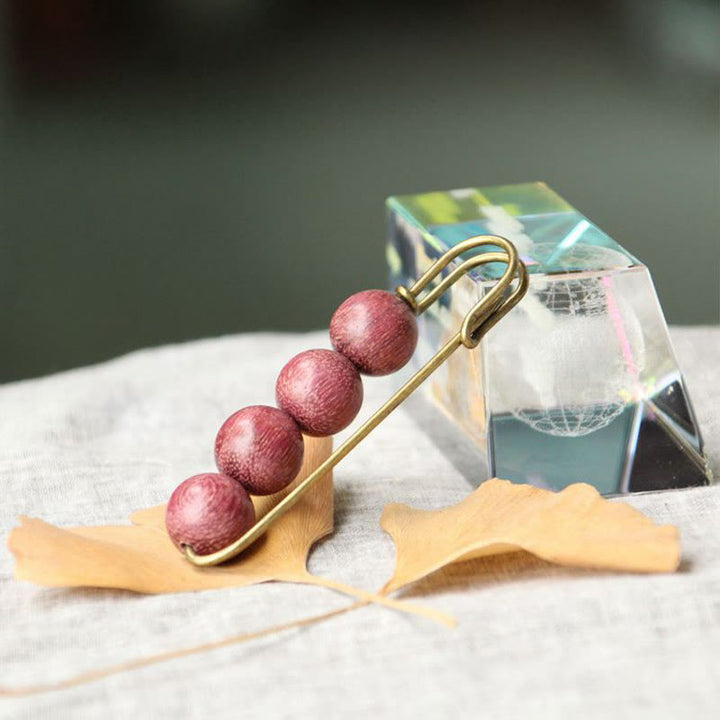 Broche curativo con cuentas de peltogyne, agathis alba, sándalo y madera de ébano de Buddha Stones