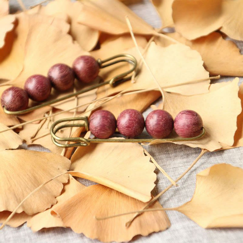 Broche curativo con cuentas de peltogyne, agathis alba, sándalo y madera de ébano de Buddha Stones