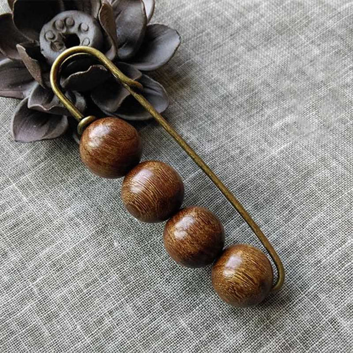 Broche curativo con cuentas de peltogyne, agathis alba, sándalo y madera de ébano de Buddha Stones