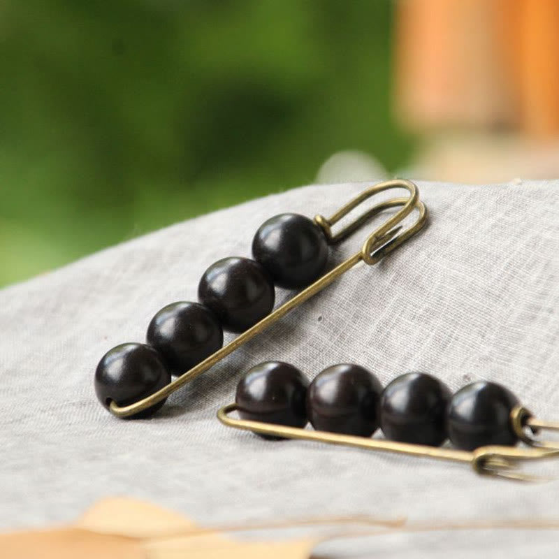 Broche curativo con cuentas de peltogyne, agathis alba, sándalo y madera de ébano de Buddha Stones