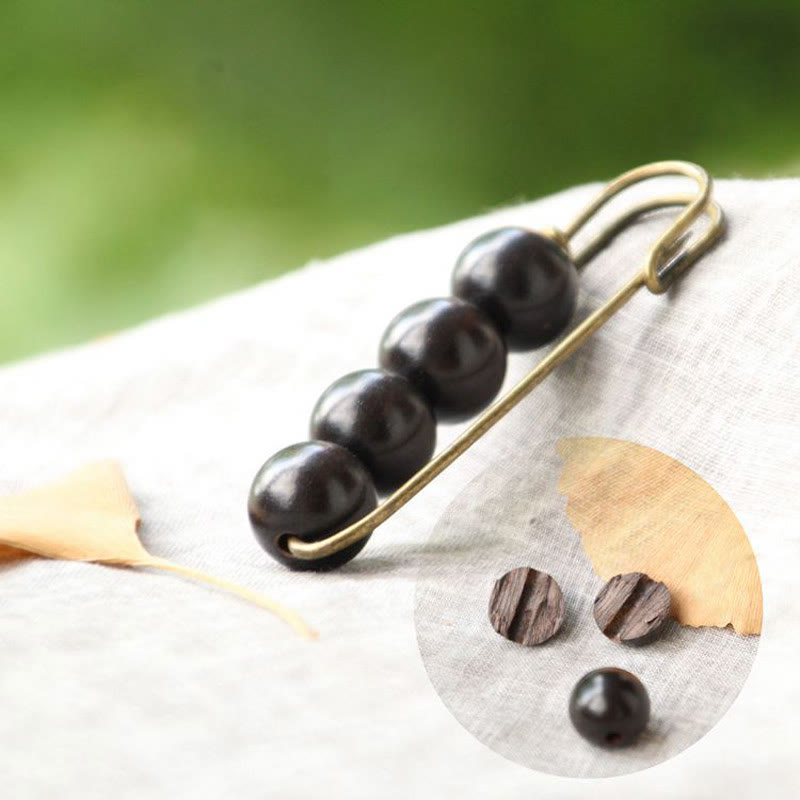 Broche curativo con cuentas de peltogyne, agathis alba, sándalo y madera de ébano de Buddha Stones