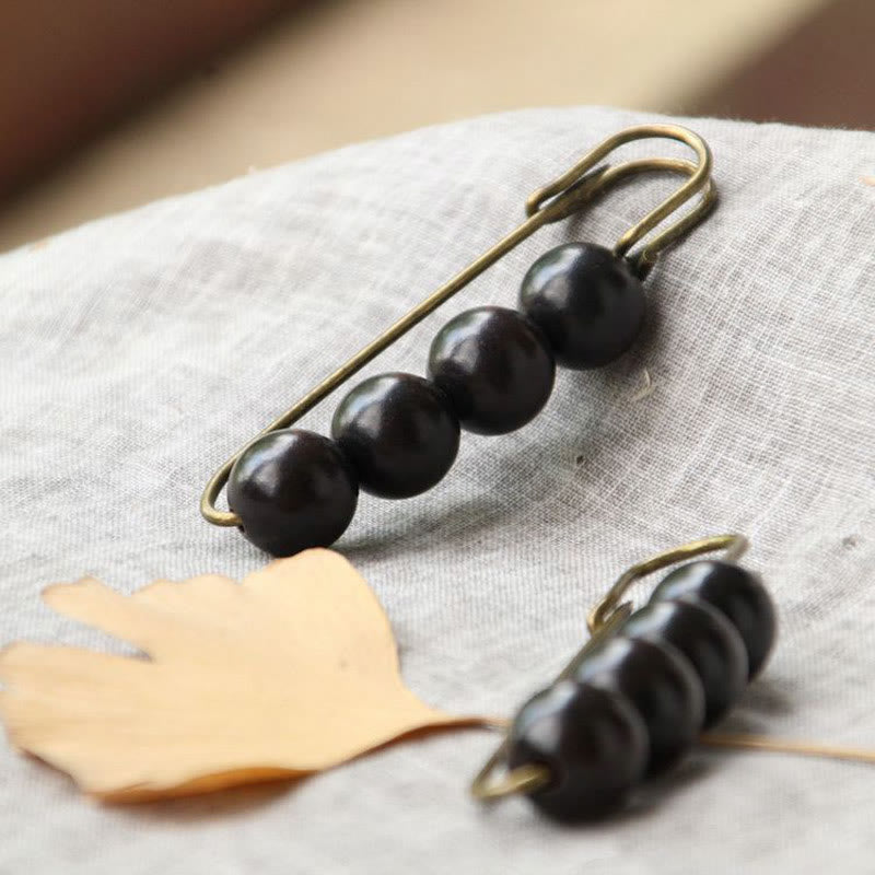Broche curativo con cuentas de peltogyne, agathis alba, sándalo y madera de ébano de Buddha Stones
