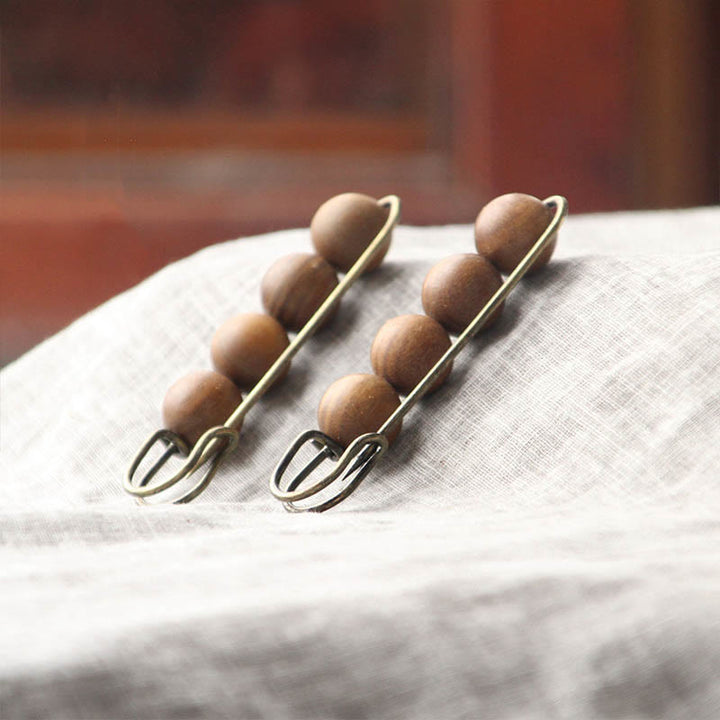 Broche curativo con cuentas de peltogyne, agathis alba, sándalo y madera de ébano de Buddha Stones