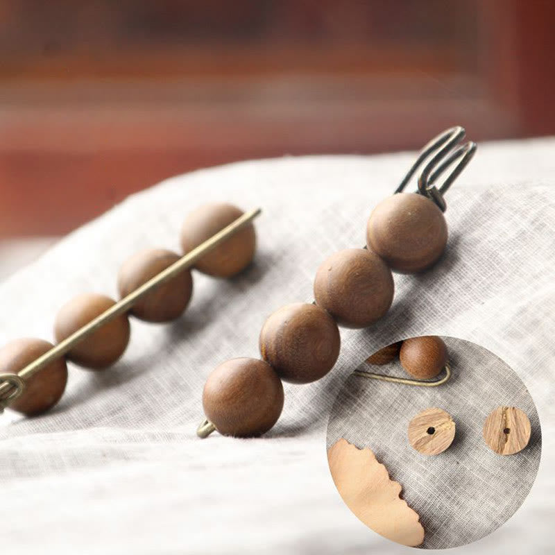 Broche curativo con cuentas de peltogyne, agathis alba, sándalo y madera de ébano de Buddha Stones