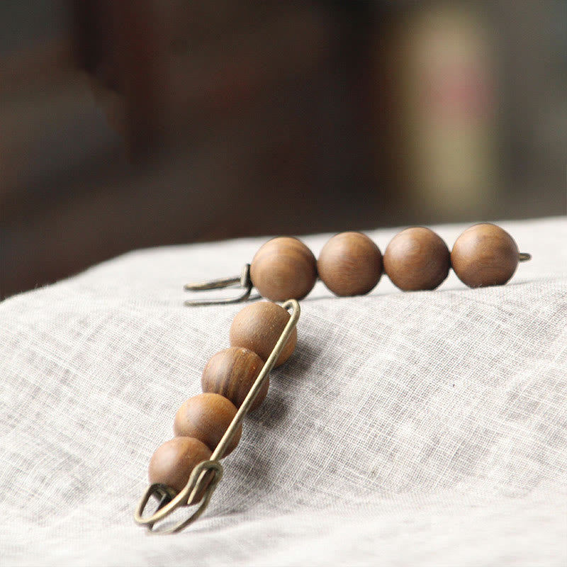 Broche curativo con cuentas de peltogyne, agathis alba, sándalo y madera de ébano de Buddha Stones