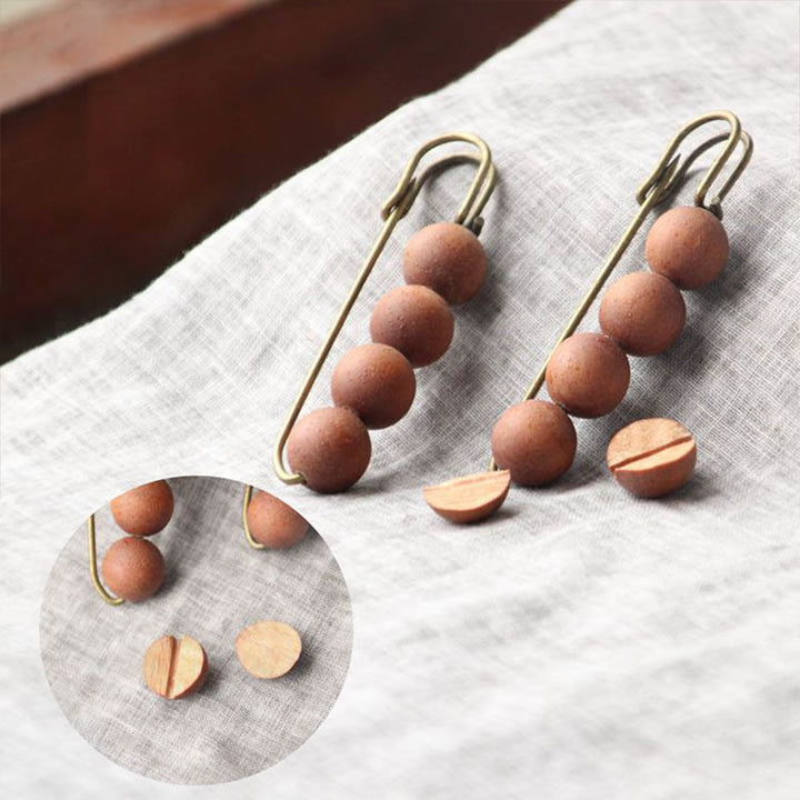 Broche curativo con cuentas de peltogyne, agathis alba, sándalo y madera de ébano de Buddha Stones