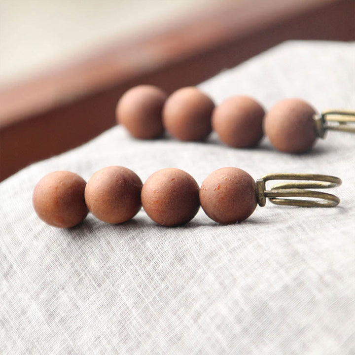 Broche curativo con cuentas de peltogyne, agathis alba, sándalo y madera de ébano de Buddha Stones