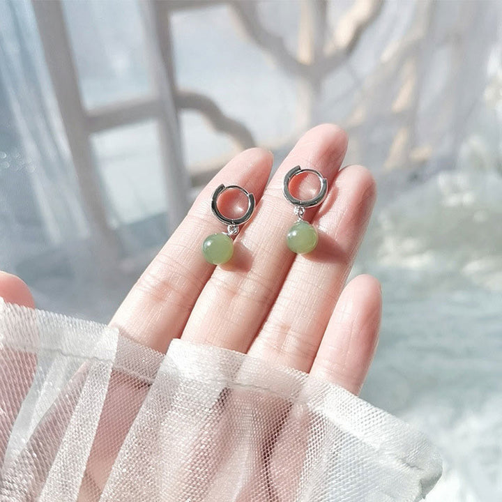 Pendientes de prosperidad con cuentas redondas de jade y Buddha Stones