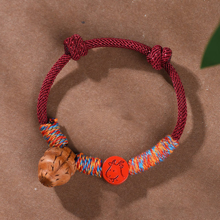 Pulsera de la suerte hecha a mano con Buddha Stones y cinabrio de hueso de melocotón con hilo rojo del zodíaco chino
