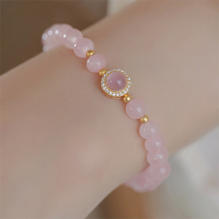 Pulsera de perlas de cristal rosa y Buddha Stones que aporta calidez