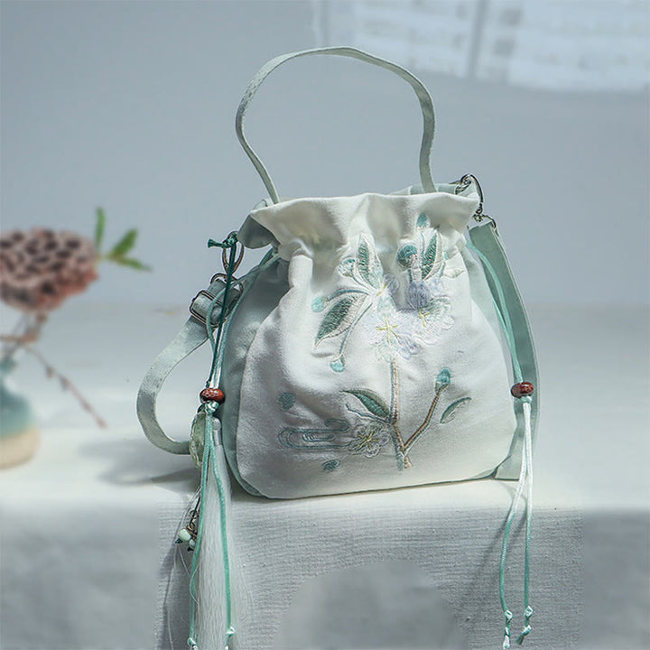 Bolso bandolera de lona con bordado de Buddha Stones y flor de pera verde.