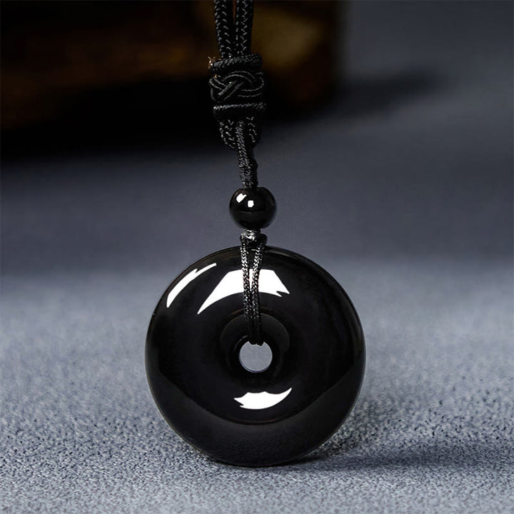Collar con colgante de cuerda de fuerza con hebilla de paz y obsidiana negra natural de Buddha Stones