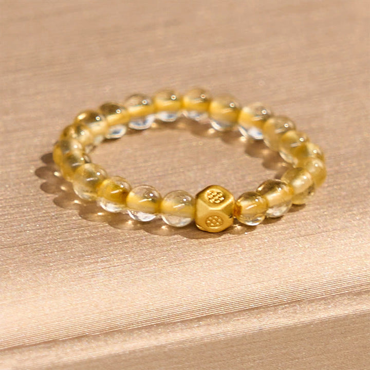 Anillo elástico de riqueza con cuentas de cuarzo rutilado dorado de 3 mm de Buddha Stones