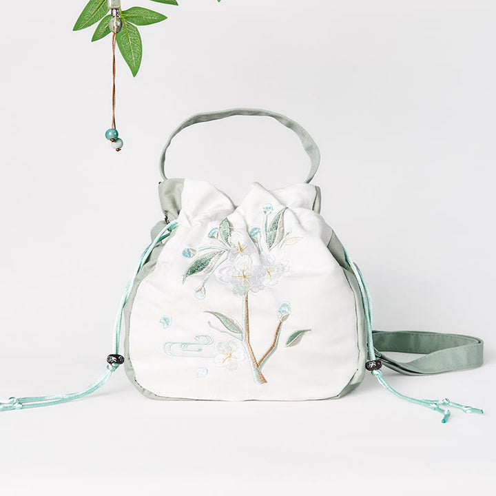 Bolso bandolera de lona con bordado de Buddha Stones y flor de pera verde.