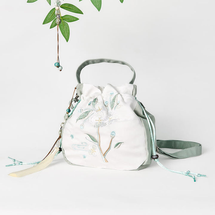 Bolso bandolera de lona con bordado de Buddha Stones y flor de pera verde.
