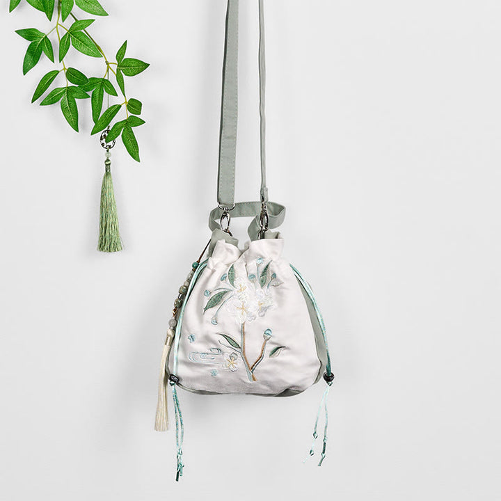 Bolso bandolera de lona con bordado de Buddha Stones y flor de pera verde.