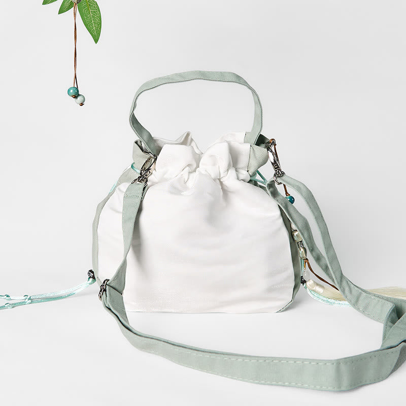 Bolso bandolera de lona con bordado de Buddha Stones y flor de pera verde.