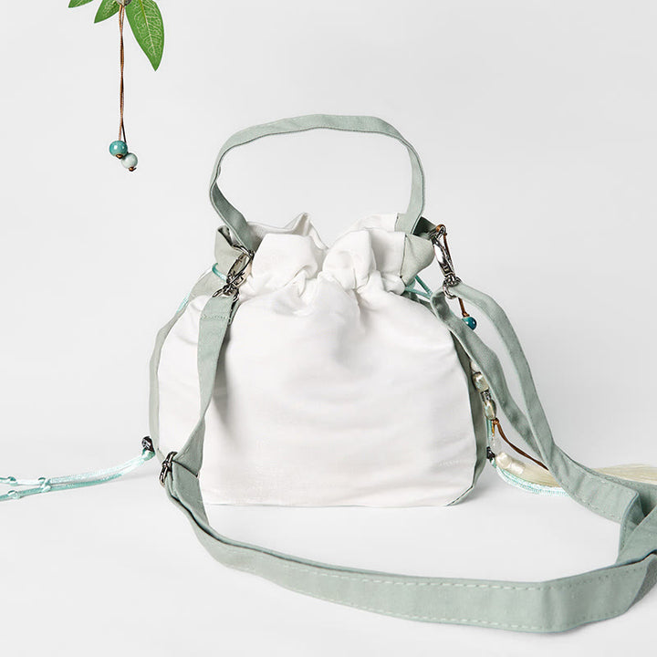 Bolso bandolera de lona con bordado de Buddha Stones y flor de pera verde.