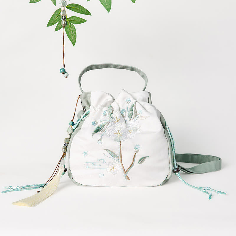 Bolso bandolera de lona con bordado de Buddha Stones y flor de pera verde.