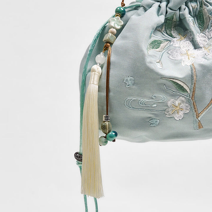 Bolso bandolera de lona con bordado de Buddha Stones, flores verdes y hojas.