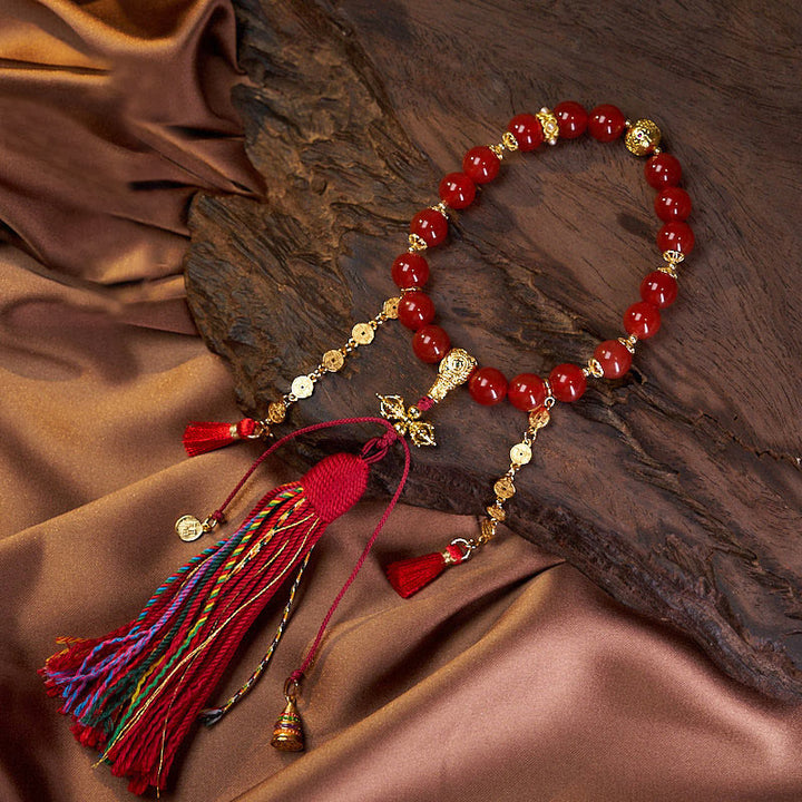 Mala de muñeca con 18 cuentas de Buddha Stones , monedas de cobre, borla tibetana, ágata roja, calmante