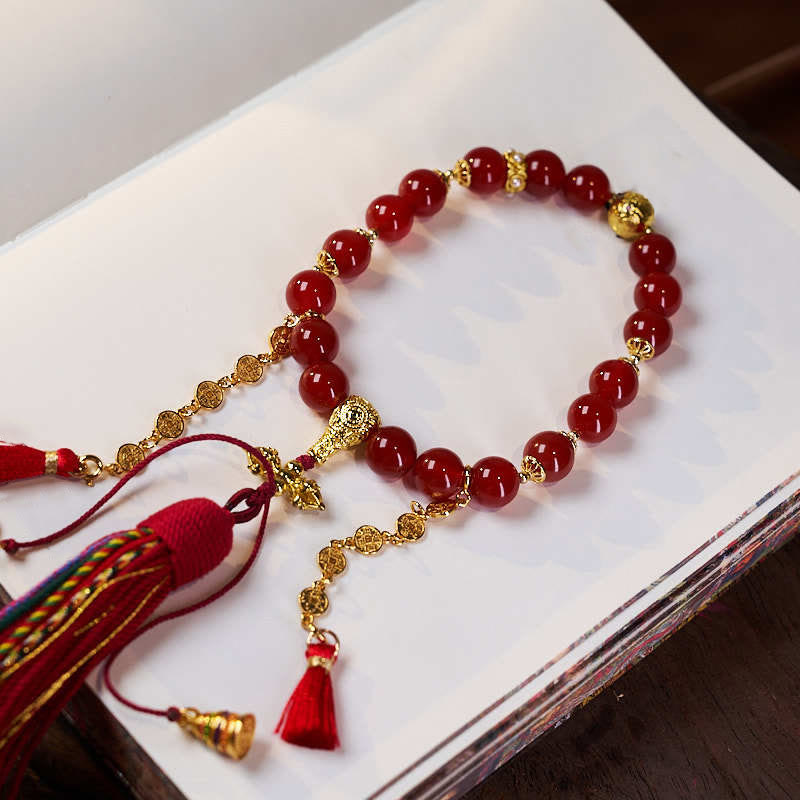 Mala de muñeca con 18 cuentas de Buddha Stones , monedas de cobre, borla tibetana, ágata roja, calmante