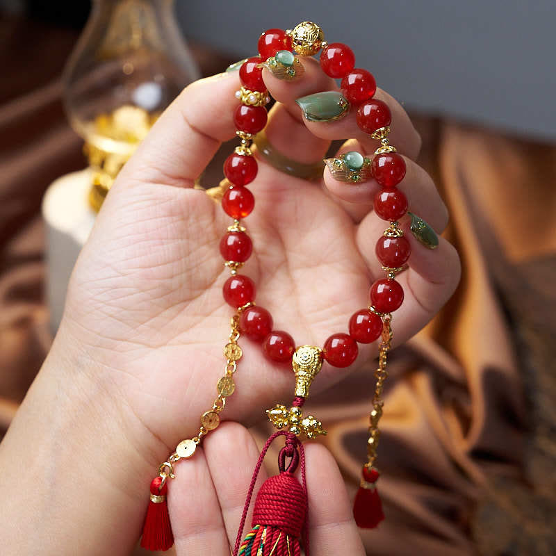 Mala de muñeca con 18 cuentas de Buddha Stones , monedas de cobre, borla tibetana, ágata roja, calmante